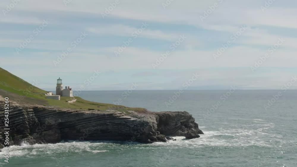 A cliff-side lighthouse on the Pacific ocean (aerial). A cliff-side lighthouse on the Pacific ocean (aerial).