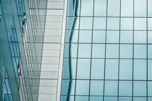 Urban abstract - Close-up of modern city glass curtain wall  windowed corner of office building..