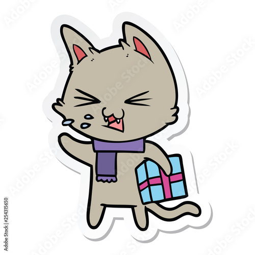 sticker of a cartoon hissing cat with christmas present