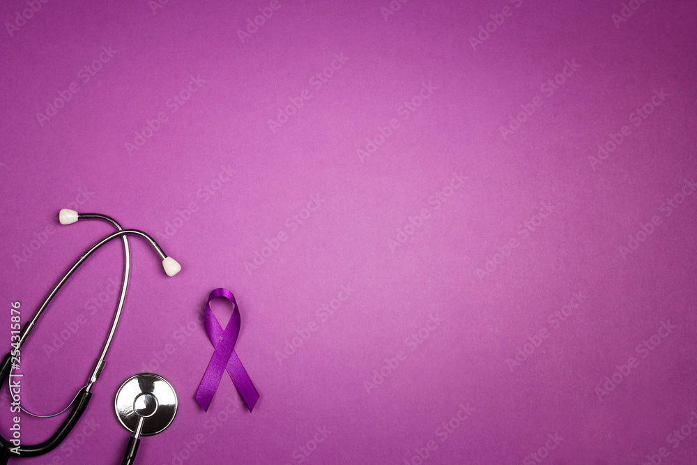 Fototapeta premium Purple epilepsy awareness ribbon with stethoscope and copy space on a purple background.