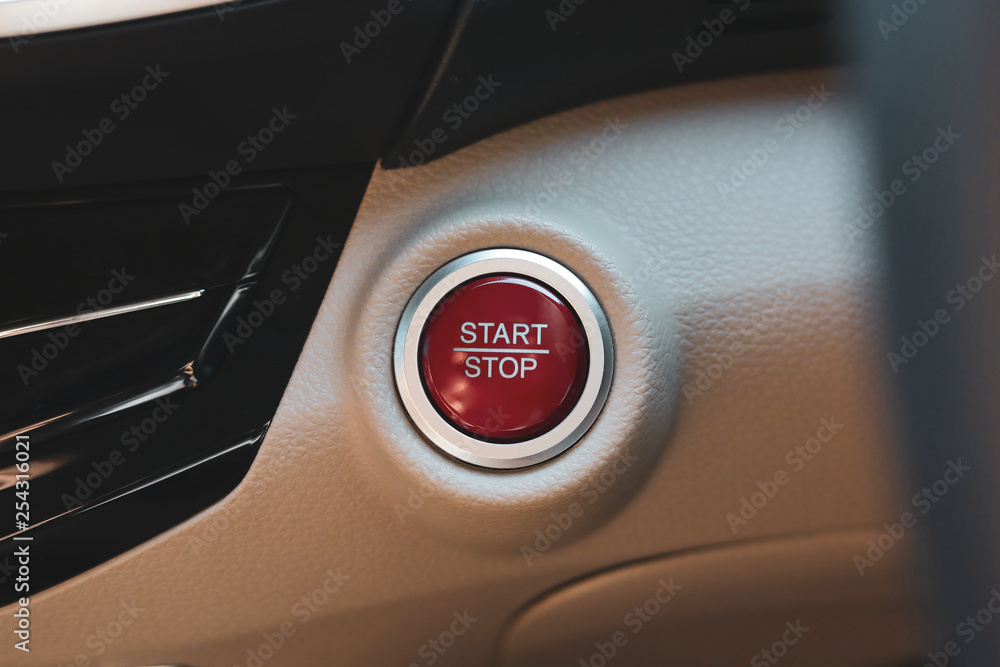 Obraz premium red start and stop button keyless engine on modern vehicle car