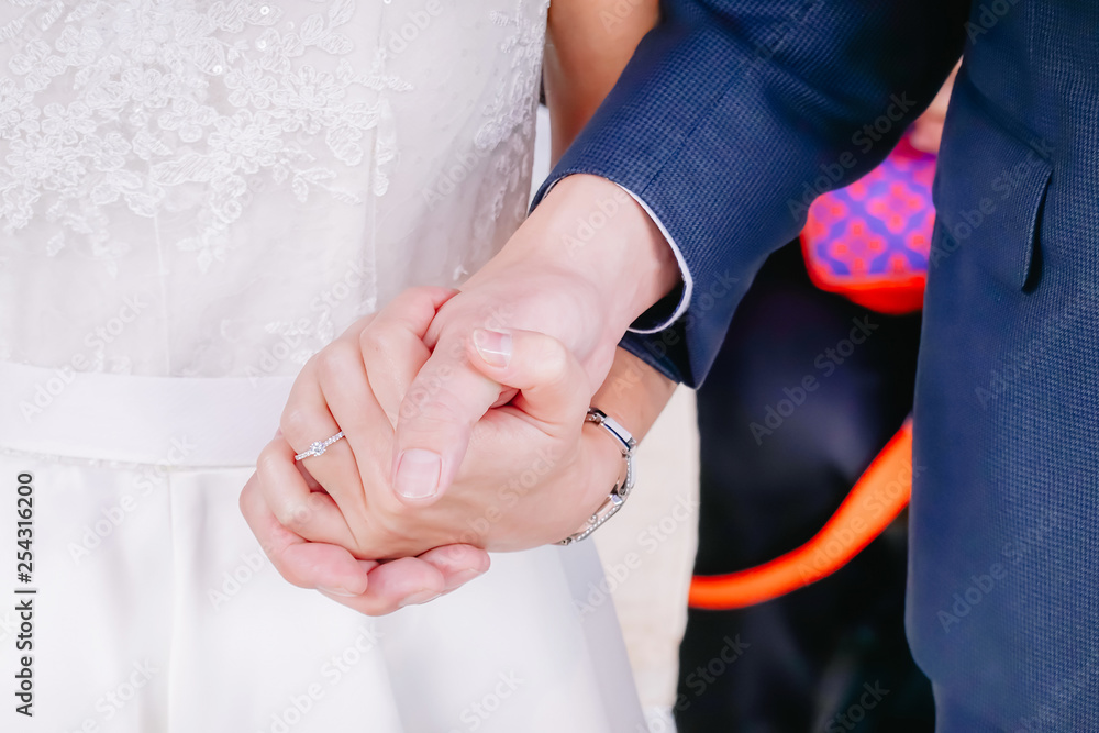 Man and woman married couple holding hands in wedding ceremony, bride and groom holding hand in wedding ceremony.