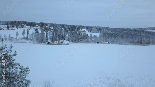 The frozen lake and forest near Borgvattnet, Sweden. Filmed with a drone during the day. photo