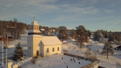Small church in Borgvattnet in Sweden. Filmed with a drone during sunrise/sunset in the winter. photo