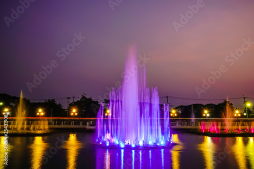 The colorful of fountain on the lake at night.