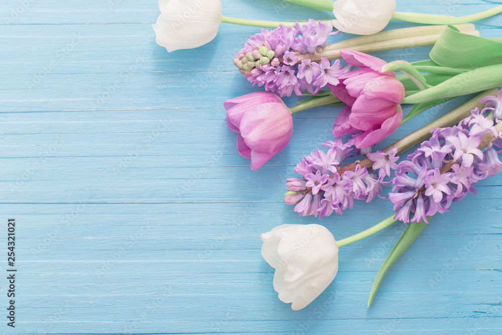 beautiful spring flowers on blue wooden background beautiful spring flowers on blue wooden background