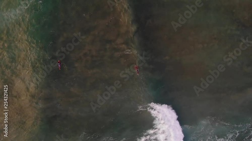 Aerial birds eye view of surfers trying to catch waves in East Java Indonesia. Seq 2