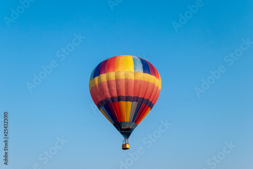 Colorful hot air balloons flying in blue sky © Mumemories