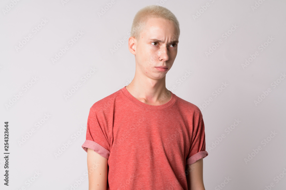 Face of young serious androgynous man thinking Face of young serious androgynous man thinking