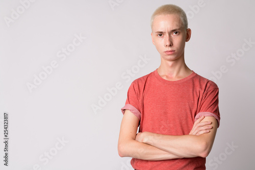 Portrait of young handsome androgynous man with arms crossed