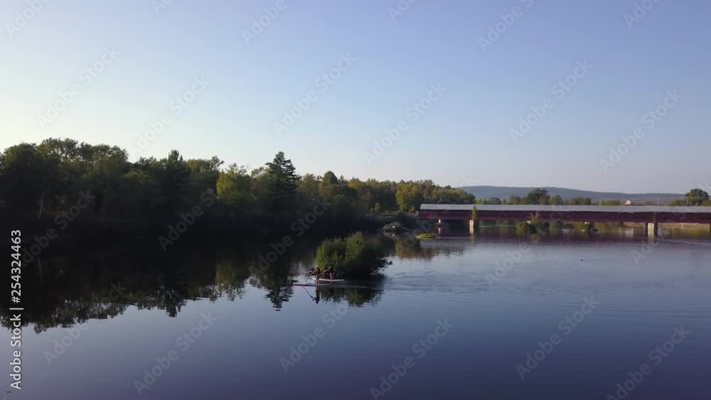 Aerial Drone Shot of Two Paddle Boarders Pulling Back to Reveal a Beautiful River and Landscape. Aerial Drone Shot of Two Paddle Boarders Pulling Back to Reveal a Beautiful River and Landscape.