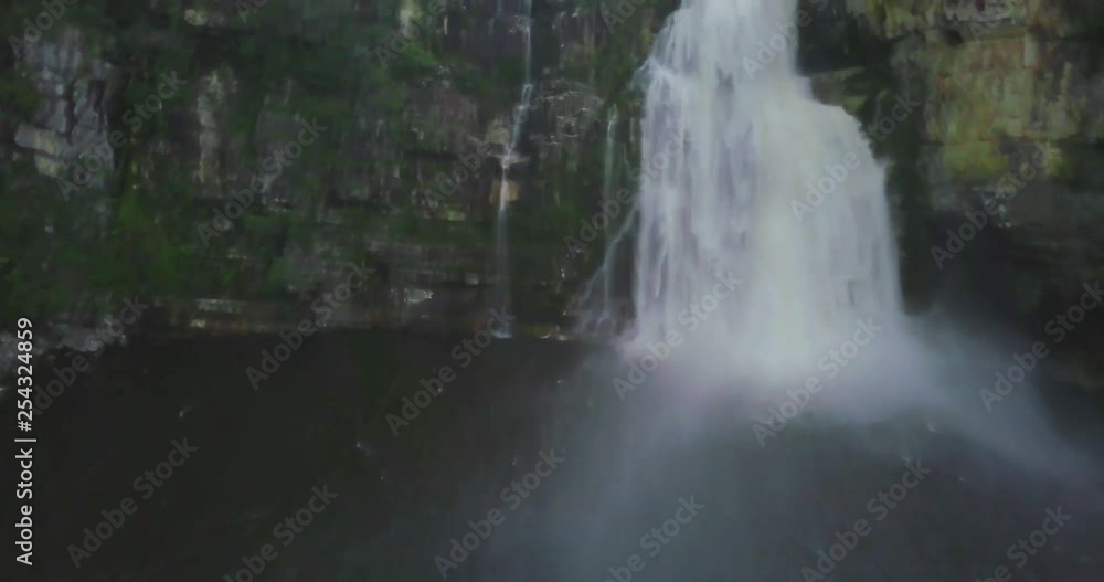 A drone flight over a large waterfall in the Chapada dos Veadeiros national park in Brazil A drone flight over a large waterfall in the Chapada dos Veadeiros national park in Brazil