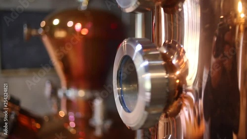 Close up footage of gauges, copper stills and gin being distilled in this step by step process of how to make gin