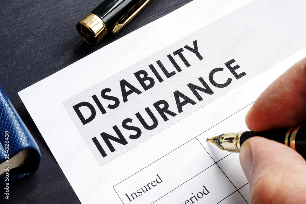 Man is filling in Disability insurance form. Man is filling in Disability insurance form.