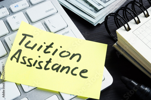 Tuition assistance handwritten on a piece of paper and calculator.