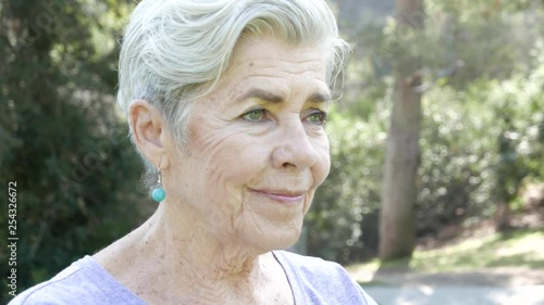 Closeup of senior citizen stretching and doing yoga in the park.