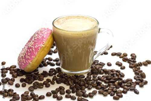 Fototapeta Naklejka Na Ścianę i Meble -  Transparent glass cup with coffee, pink donut and coffee beans on white background. Bright tone, soft focus