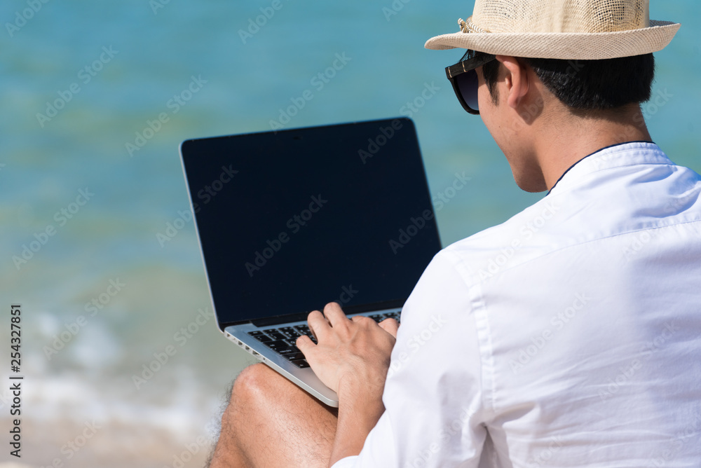Busy freelance man with laptop outdoor.  Businessman corporate city life outside with lifestyle technology. Handsome man connect internet outdoor on the beach. Internet technology lifestyle concept