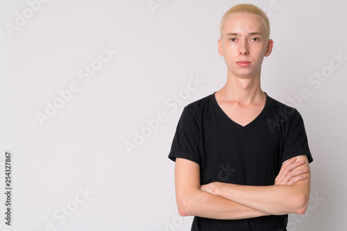 Portrait of young handsome androgynous man with arms crossed