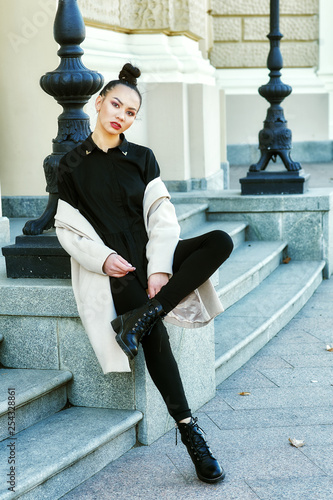 Young beautiful woman in spring city . Girl posing on the street