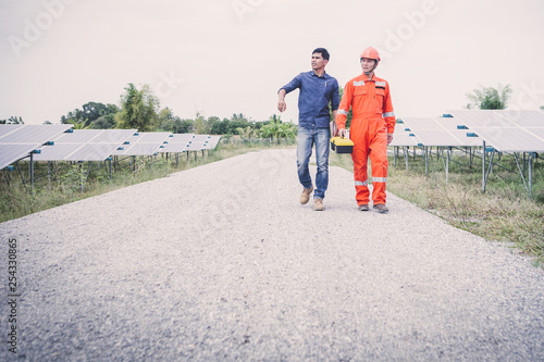 engineer or electrician inspect and checking solar equipment ;smart technology for operation of solar power plant by smart operator