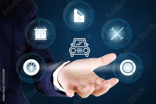 Businessman holding a car with service icons, Concept of car checking, repair and maintenance.