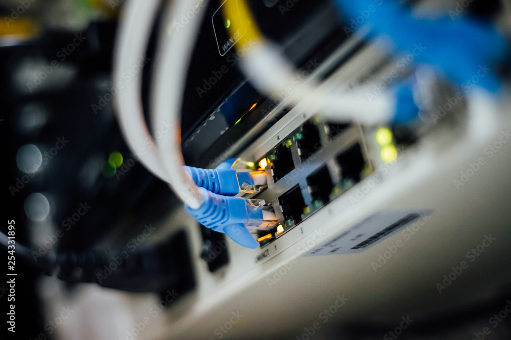 Network cables connected in a technology data center. Network cables connected in a technology data center.