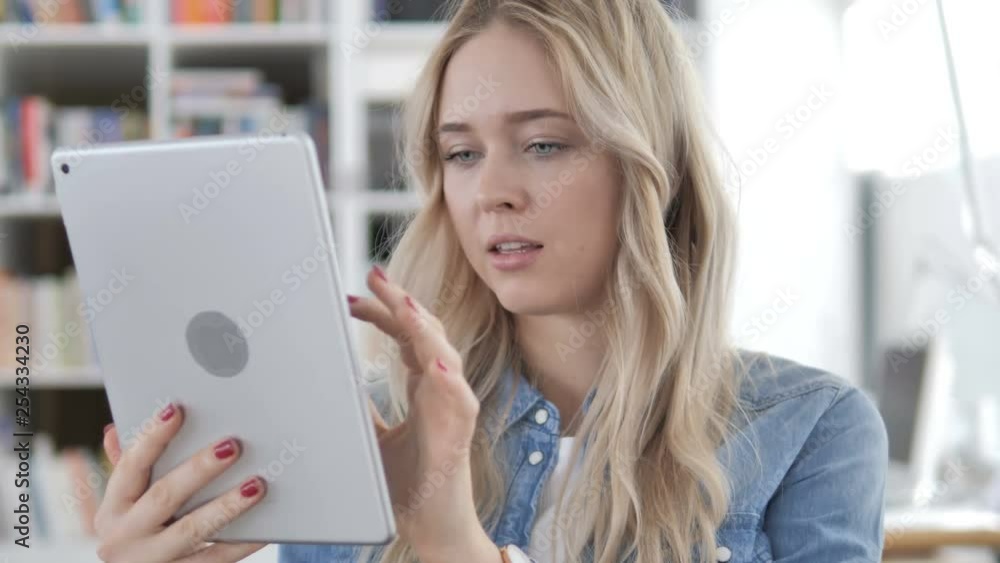 Young Woman Browsing Internet on Tablet Young Woman Browsing Internet on Tablet