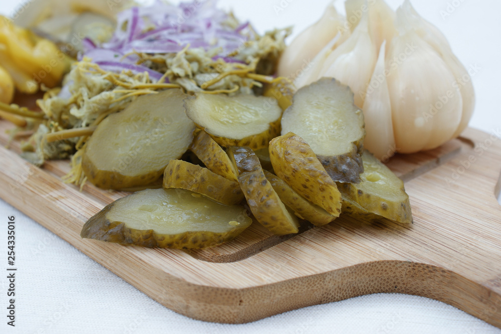 pickled cucumbers. cucumbers and other pickled vegetables on a wooden board pickled cucumbers. cucumbers and other pickled vegetables on a wooden board