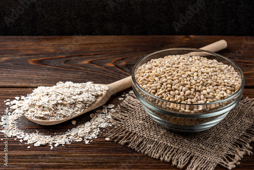 Pearl barley on dark wooden background. photo