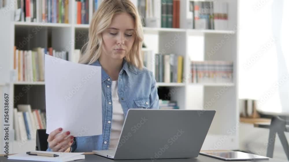 Young Woman Working on Documents and Laptop, Paperwork Young Woman Working on Documents and Laptop, Paperwork
