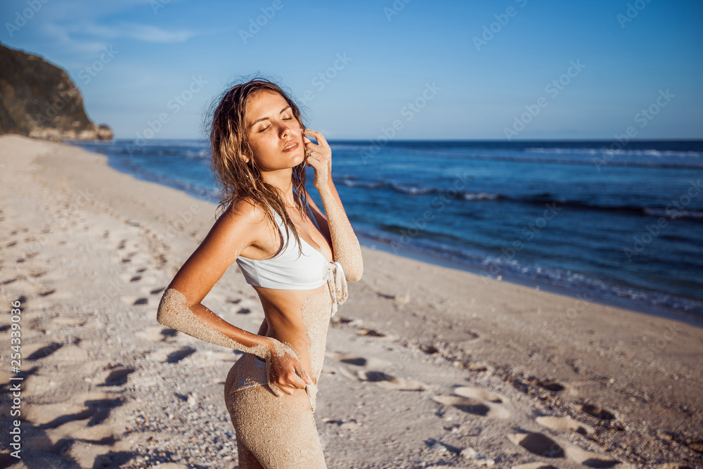Girl in white swimsuit on the beach Girl in white swimsuit on the beach
