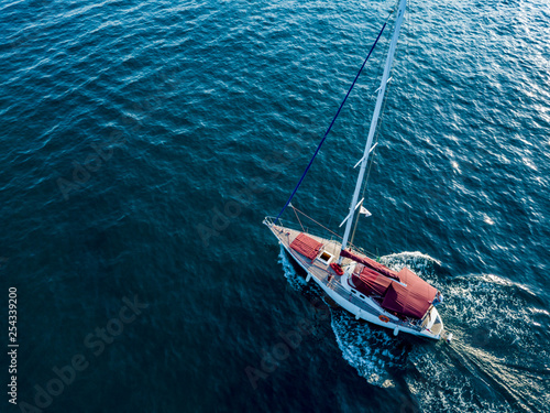 a lone yacht swim in deep blue ocean top view