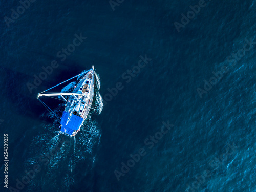 a lone yacht swim in deep blue ocean top view