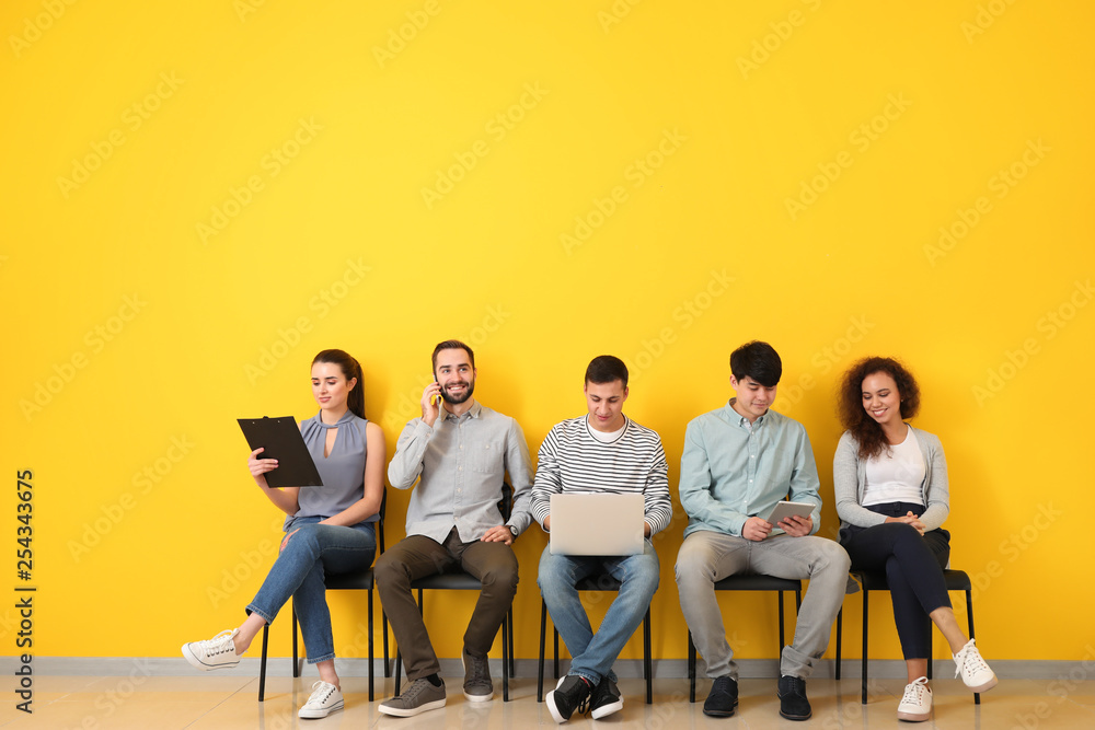 Young people waiting for job interview indoors - obrazy, fototapety, plakaty 