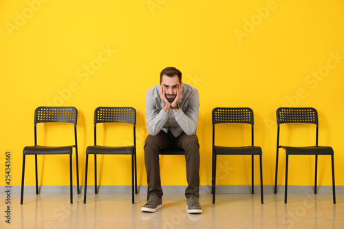 Young man waiting for job interview indoors photo