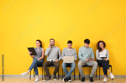Young people waiting for job interview indoors photo