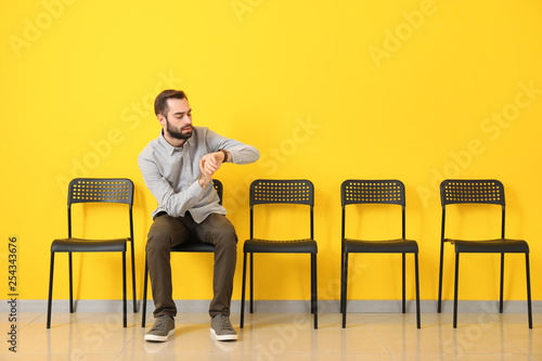 Young man waiting for job interview indoors photo