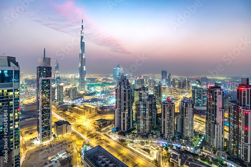 Colourful nighttime skyline of a big modern city. Dubai, United Arab Emirates. Aerial view.