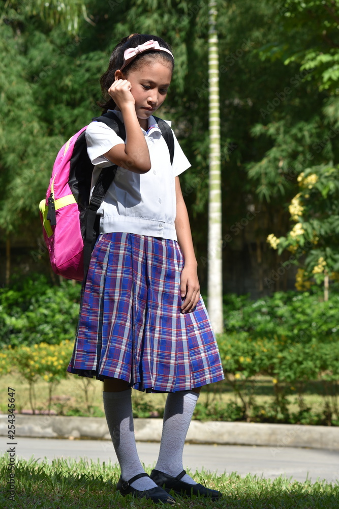 Depressed Female Student Wearing School Uniform With Notebooks Depressed Female Student Wearing School Uniform With Notebooks