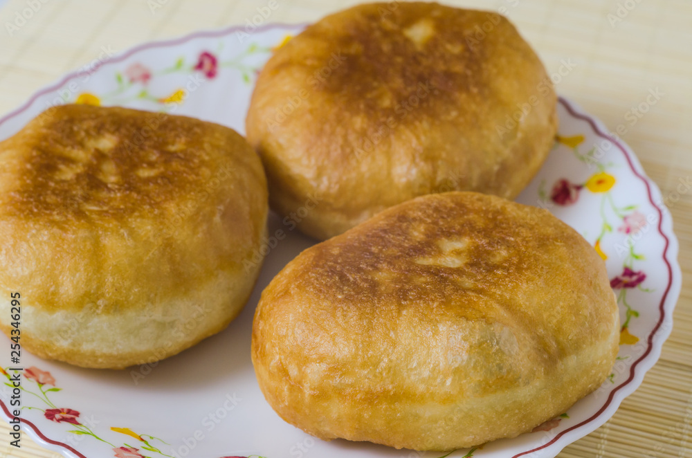 Traditional Russian meat pies belyashi on a plate. Traditional Russian meat pies belyashi on a plate.