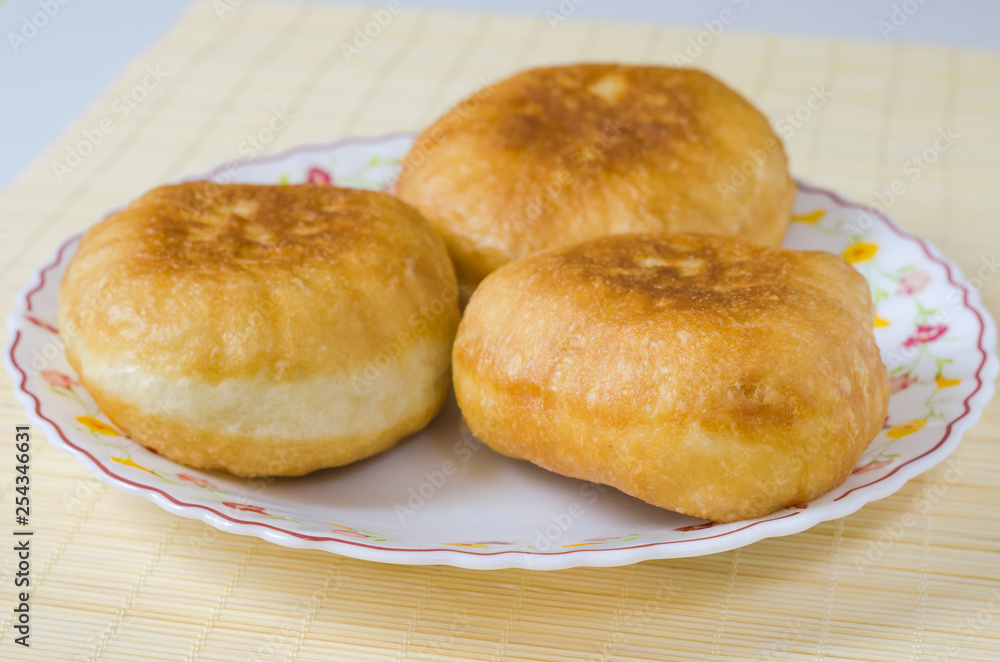 Traditional Russian meat pies belyashi on a plate. Traditional Russian meat pies belyashi on a plate.