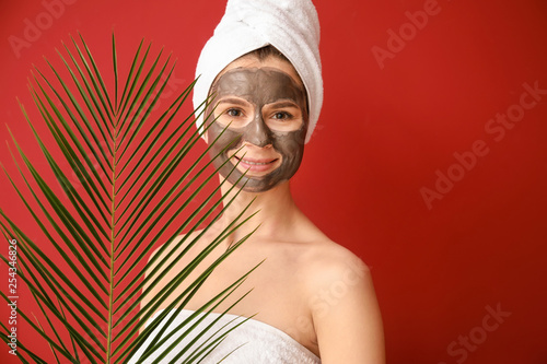 Woman with facial mask and ...