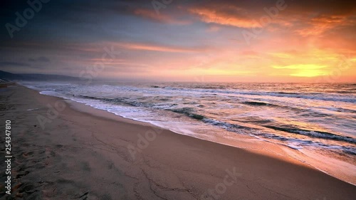 Video with beautiful sunrise view of a sandy beach of the Black sea, Bulgaria