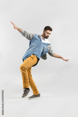 Fashionable young man on light background