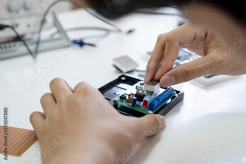 Technician checks the electronic device.