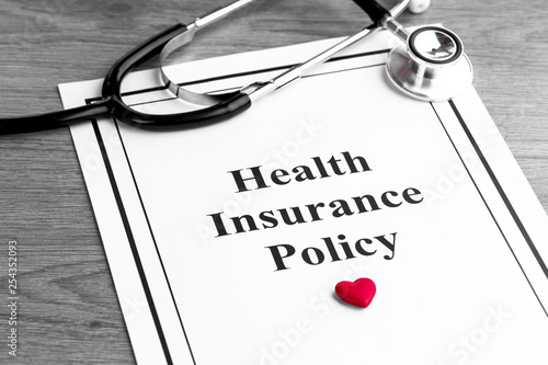Insurance policy. Medical stethoscope and red heart on table. Business and medical background concept