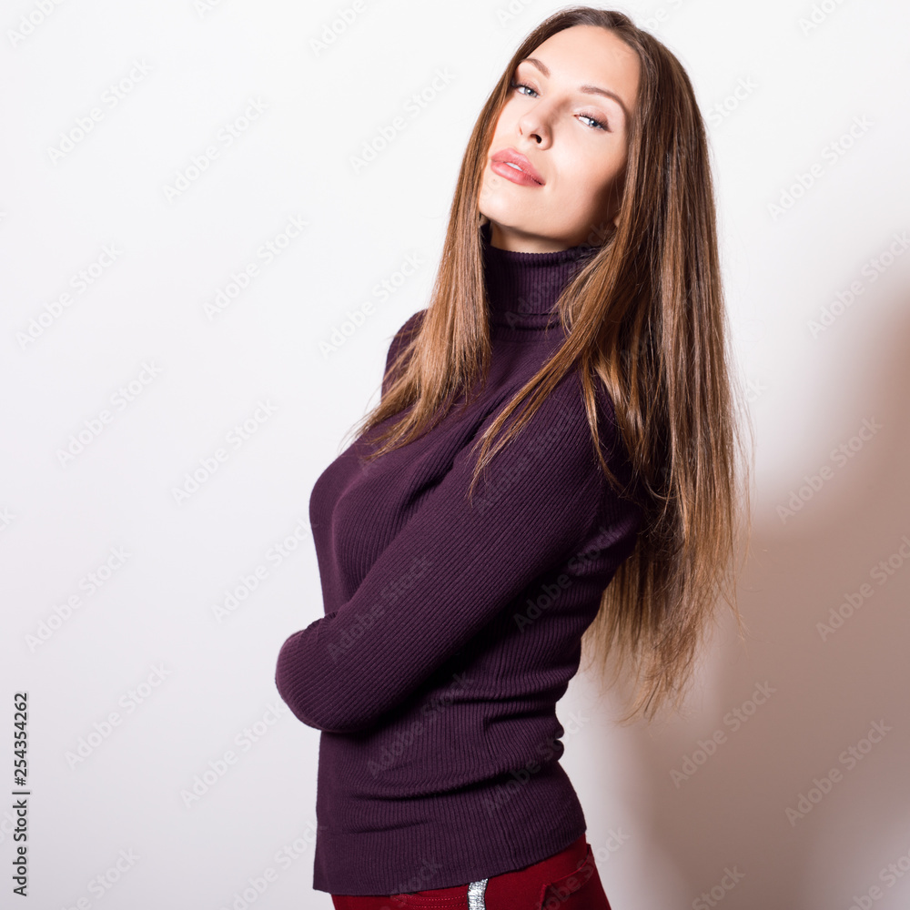 Beautiful young girl in violet golf posing in studio. Beautiful young girl in violet golf posing in studio.