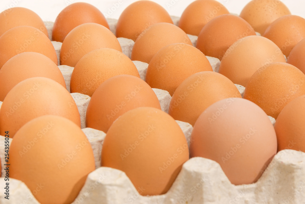 Brown eggs in egg tray close-up at selective focus Brown eggs in egg tray close-up at selective focus