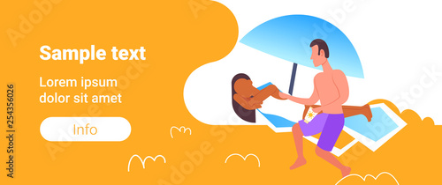 man applying suntan cream to his african american girlfriend sunbathing on beach sunbed sun protection cosmetic summer vacation concept full length horizontal copy space